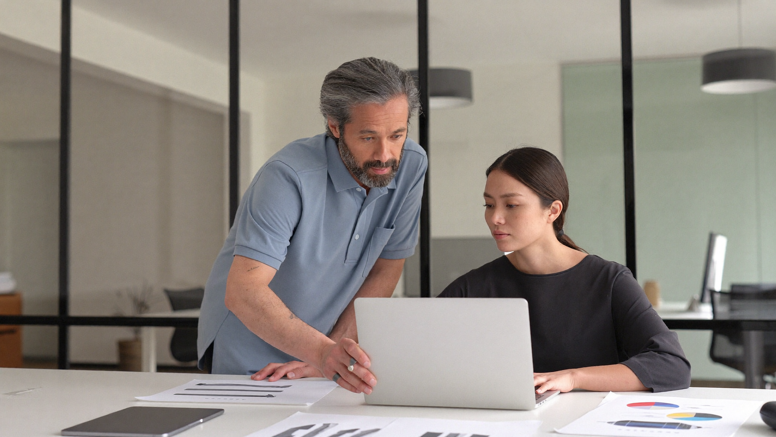 Foreign specialist working with an Indonesian employee during workplace onboarding